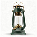 Antique-style green camping lantern with glass reservoir and brass accents